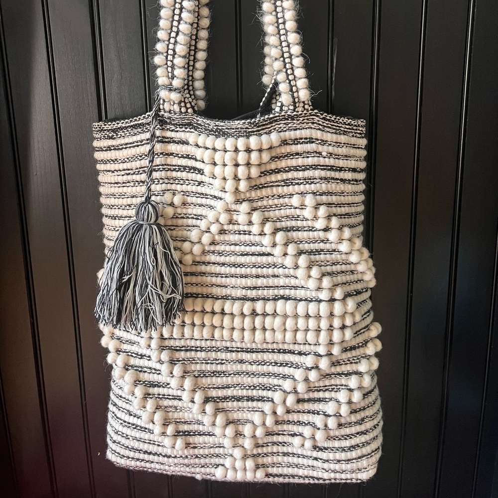 Black and white woven bag with tassel